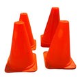 Plastic ground cones marking boundaries on a grassy field during a soccer training session.