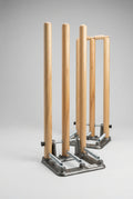 Close-up of PNARRA wooden cricket stumps and heavy metal spring base